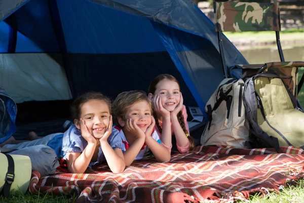 Sisters spending time in a tent on camping. Children using tablet playing games  online during summer vacation - a Royalty Free Stock Photo from Photocase