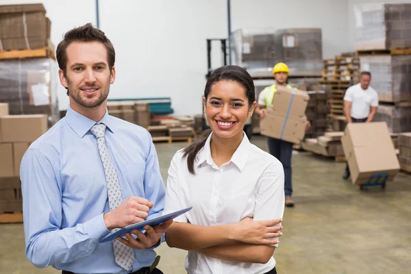Smiling warehouse managers working together — Stock Photo, Image