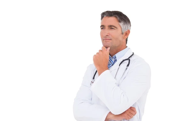 Doctor thinking with hand on chin — Stock Photo, Image