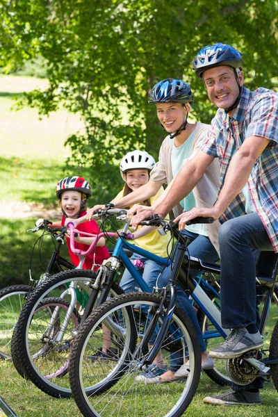 Happy family on their bike at park — Stock Photo, Image