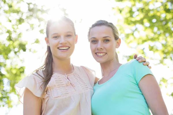 Happy friends smiling at camera in park — Stock Photo, Image