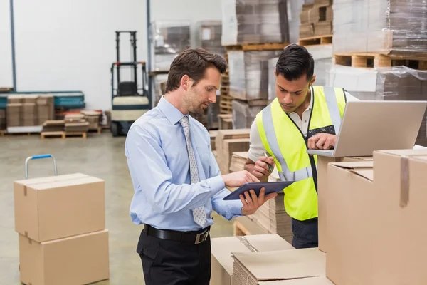 Warehouse worker and manager working — Stock Photo, Image