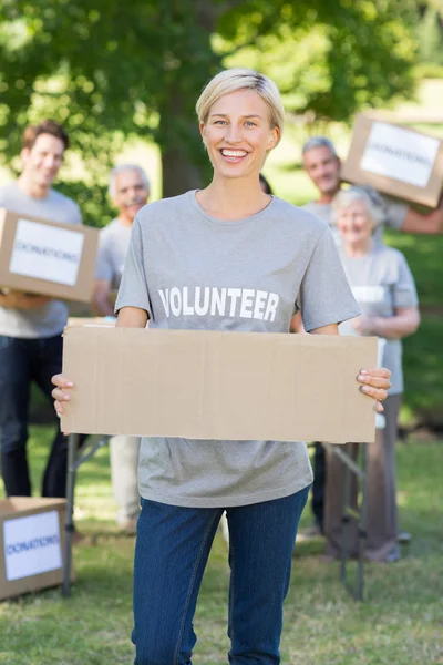 Happy volunteer blonde holding blank — Stock Photo, Image