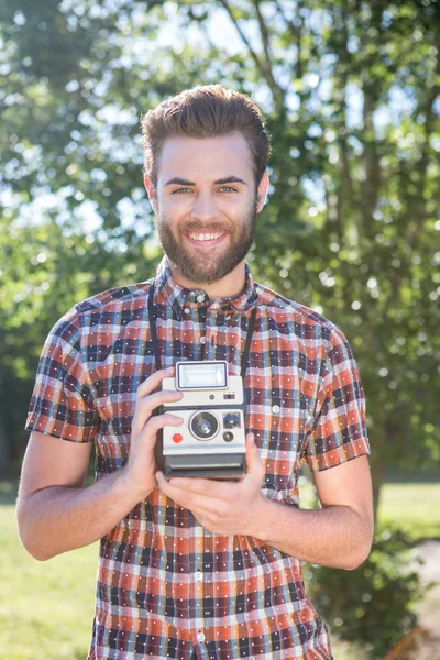 Knappe hipster houden vintage camera — Stockfoto