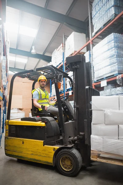 Smiling driver operating forklift machine — Stock Photo, Image