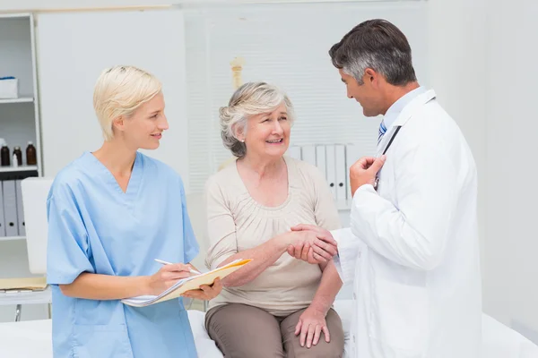 Doctor and patient shaking hands — Stock Photo, Image