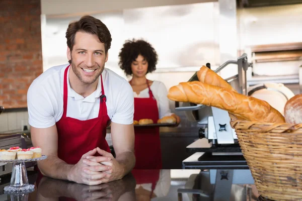 Smiling waiter in front of his colleague — Stock Photo, Image