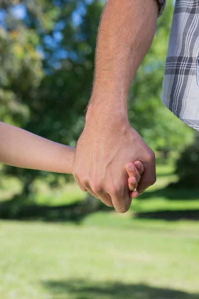 Padre e hija tomados de la mano en el parque — Foto de Stock