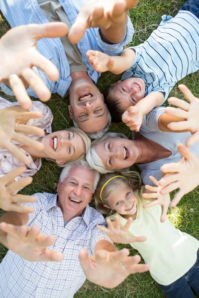 Stretched out family raising up their hands — Stock Photo, Image