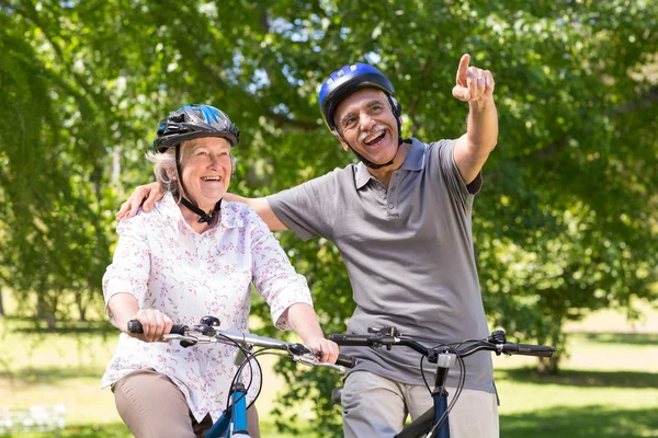 Feliz pareja de ancianos en su bicicleta — Foto de Stock