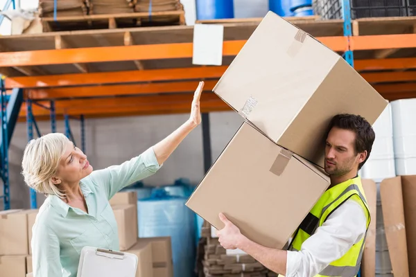 Worker balancing heavy cardboard boxes — Stock Photo, Image