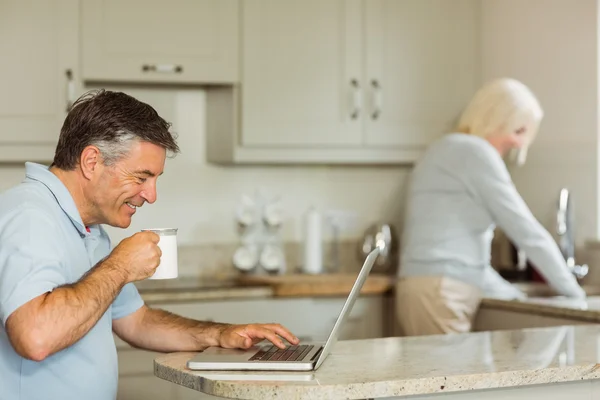 Happy mature man using laptop — Stock Photo, Image