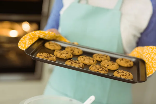 Woman showing tray of fresh cookies — Stock Photo, Image