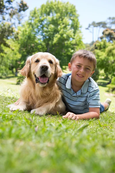 Little boy with his dog in the park Royalty Free Stock Images