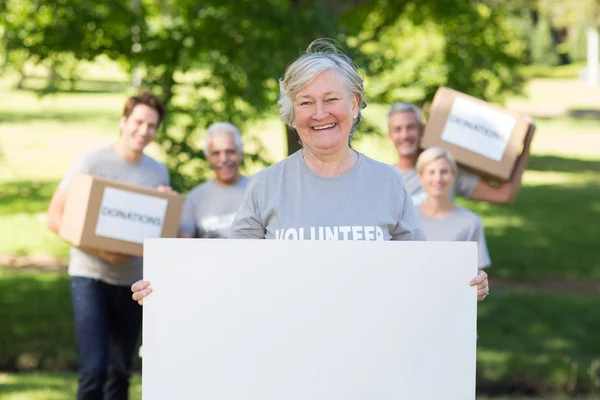 Volunteer grandmother holding blank — Stock Photo, Image