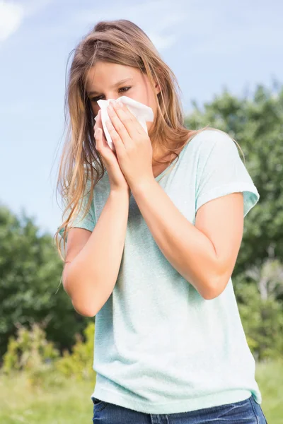 Pretty blonde blowing her nose — Stock Photo, Image