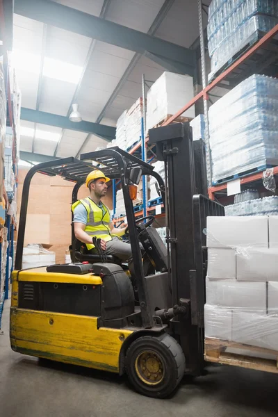 Focused driver operating forklift machine — Stock Photo, Image