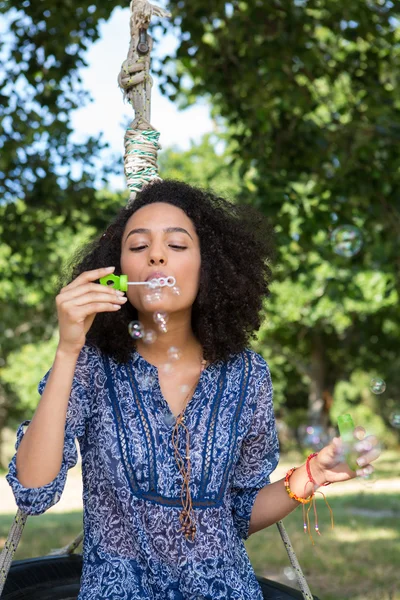 Pretty young woman in tire swing — Stock Photo, Image