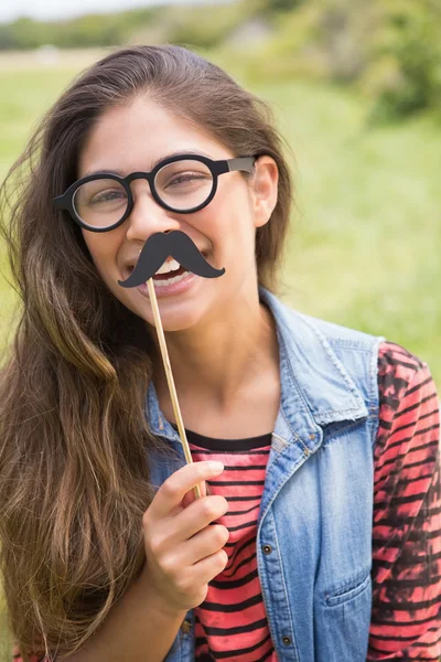 Pretty brunette with fake mustache — Stock Photo, Image