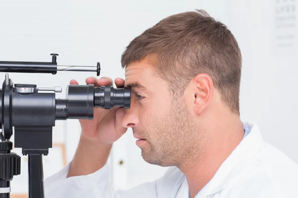 Optician usando lâmpada de fenda na clínica — Fotografia de Stock
