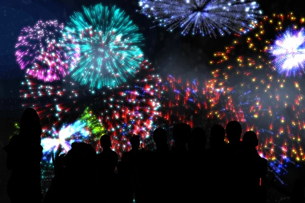 Silhouettes of cheering people against fireworks — Stock Photo, Image