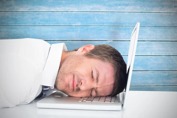 Tired businessman resting on laptop — Stock Photo, Image