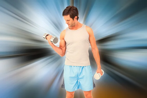 Fit young man exercising with dumbbells — Stock Photo, Image