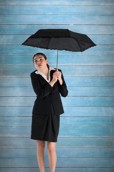 Businesswoman holding umbrella — Stock Photo, Image