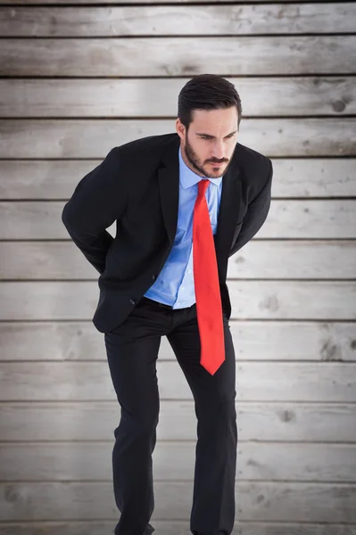 Uomo d'affari contro assi di legno — Foto Stock