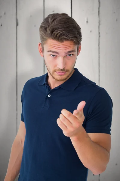 Handsome young man pointing at camera — Stock Photo, Image