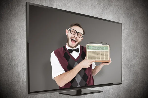 Geeky hipster holding a retro radio — Stock Photo, Image