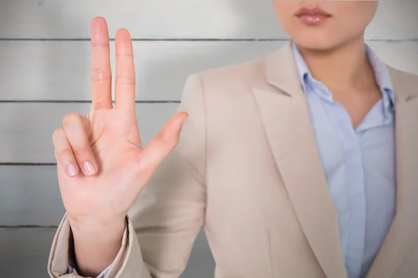 Businesswoman touching against wooden planks — Stock Photo, Image