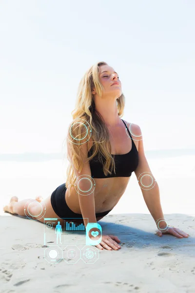 Fit blonde in cobra pose on the beach — Stock Photo, Image