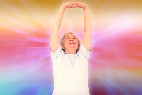 Senior woman stretching her arms — Stock Photo, Image