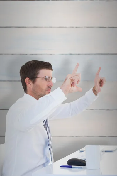 Businessman holding hands up at desk — Stock Photo, Image