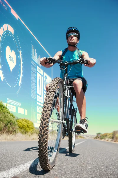 Lekkoatletycznego mężczyzna na rowerze na otwartej drodze — Zdjęcie stockowe