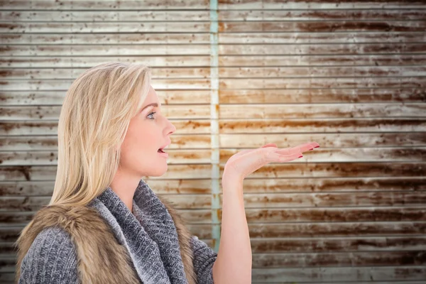 Blonde in winterkleren met uitdelen — Stockfoto