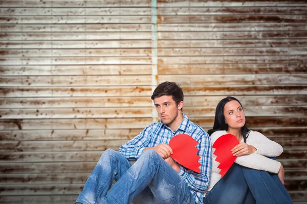 Couple sitting on floor with broken heart — Stock Photo, Image