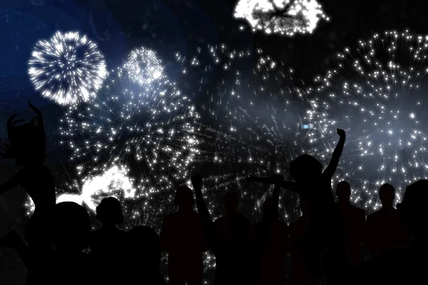 Silhouettes of cheering people against fireworks — Stock Photo, Image