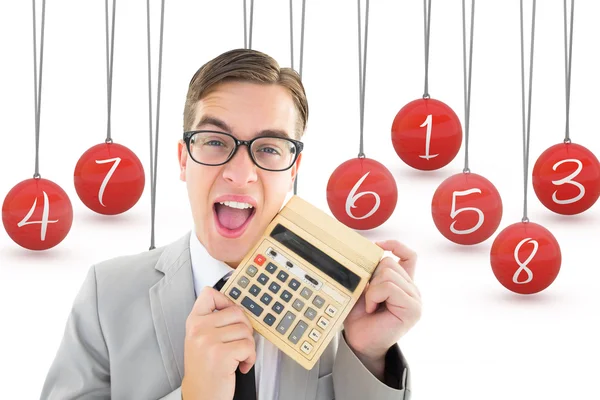 Geeky smiling businessman showing calculator — Stock Photo, Image