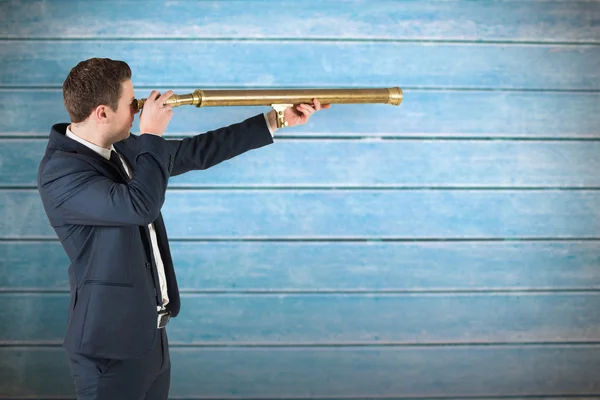 Businessman looking through telescope — Stock Photo, Image