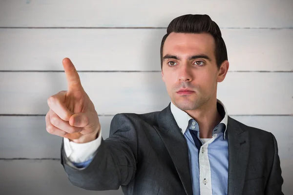 Handsome young businessman pointing — Stock Photo, Image