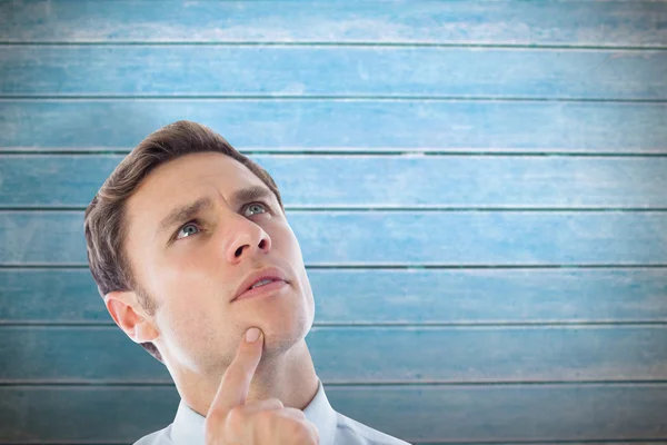 Thinking businessman with finger on chin — Stock Photo, Image