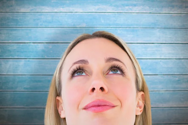 Smiling blonde woman looking up — Stock Photo, Image