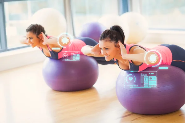 Two fit women exercising on fitness balls — Stock Photo, Image