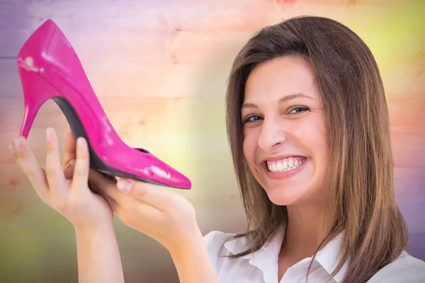 Elegant brunette admiring a shoe — Stock Photo, Image