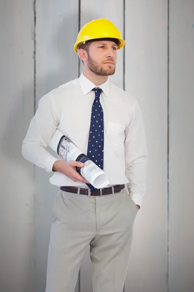 Architect posing with hard hat and plan — Stock Photo, Image