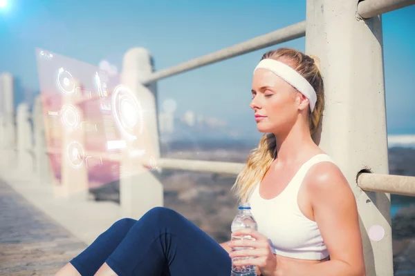 Fit blonde sitting on the pier — Stock Photo, Image