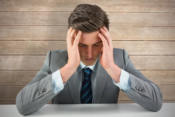 Anxious businessman against wooden surface — Stock Photo, Image