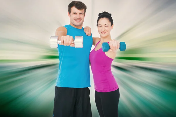 Fit man and woman lifting dumbbells — Stock Photo, Image